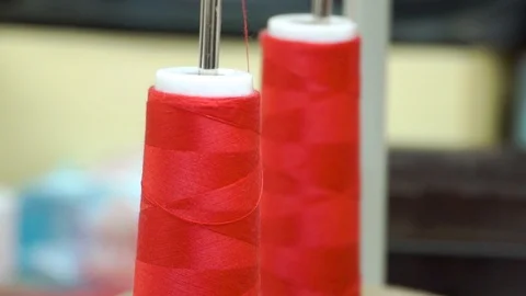 Two bobbins with red thread, polyamide used for the manufacture of knitted Stock Footage 104237106