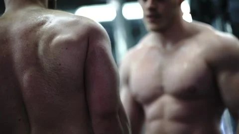 Two bodybuilders perfect their form and technique to build impressive muscles Stock Footage 241160726