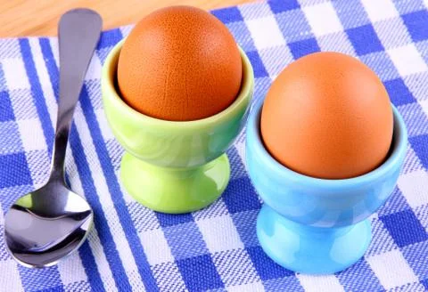 Two boiled eggs with spoon Stock Photos