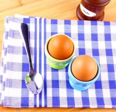 Two boiled eggs with spoon Stock Photos