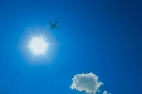 Two bombers flying through the sun down Stock Photos