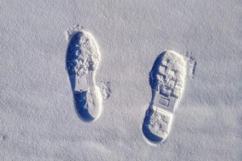 Two boot prints on the surface of the snow Stock Photos