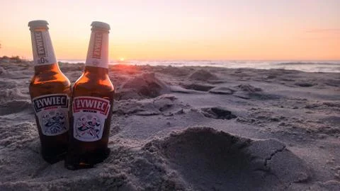 Two bottles of beer on the beach during sunset by the Baltic Sea Stock Photos