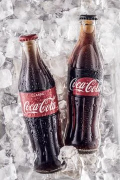 Two bottles of Coca Cola, classic and sugar-free on a background of ice cubes Foto stock