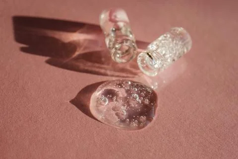 Two bottles of cosmetic gel on a pink background. Stock Photos