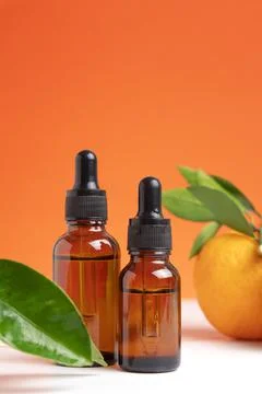 Two bottles different size with orange essential oil for aromatherapy. Stock-Fotos