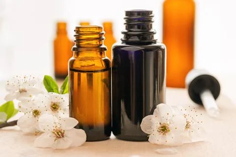 Two bottles of essential oil with cherry blossoms Stock Photos