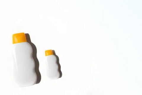 Two bottles of sunscreen on a white background Stock Photos