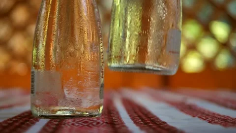 Two bottles of water are cleared from the table. Condensation on bottles of Stock Footage 247670291