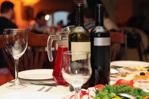 Two bottles of wine on a table in a restaurant Stock Photos