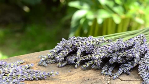 Two bouquets of lavender on a wooden table against a background of nature Stock Footage 157724082