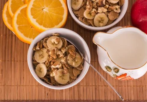 Two bowls of cereal with nuts and banana Stock Photos