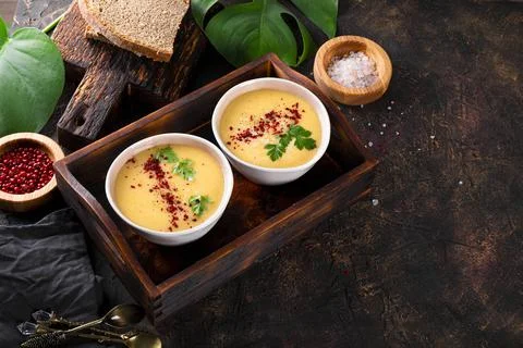 Two bowls of split pea puree soup on the table free space for text Stock Photos