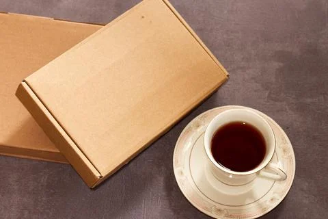 Two box and a cup of tea on concrete background Stock Photos