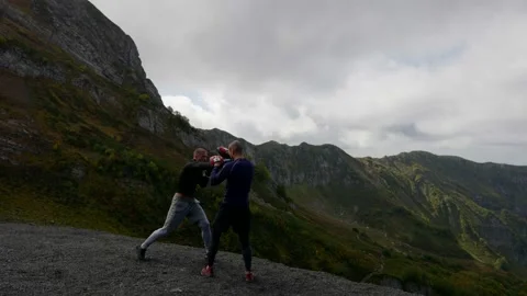 Two boxers are training in nature in picturesque landscape with mountains Vídeo Stock 163363137