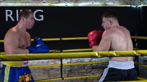 Two boxers fight in boxing ring HD slow motion video. Sparring: punches defense Stock Footage 70385747