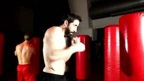 Two boxers train by throwing punches in the gym. Stock Footage 139888131