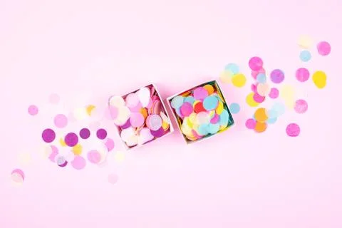 Two boxes with confetti on pink background. Stock Photos