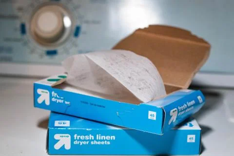 Two boxes of fresh linen laundry dryer sheets placed on top of a dryer Stock Photos
