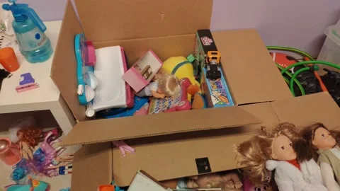 Two boxes full of children's toys and doll clutter on the floor in the 動画素材 220429548