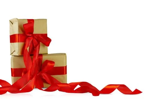 Two boxes packed with craft paper, decorated with red ribbons. Stock Photos