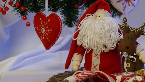 Two Boxes With Photo Frames Are Placed Near Red Santa Claus and His Hand Made Stock Footage 72548783