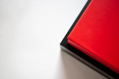 Two boxes red and black in a stack on a white background Foto stock