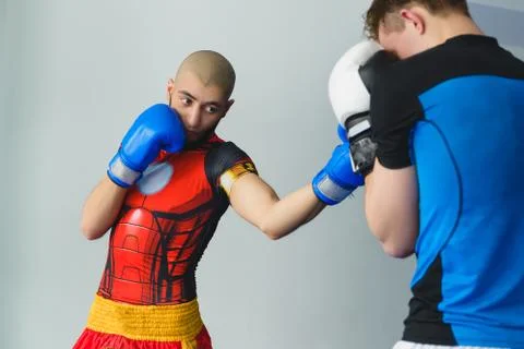 Two boxing men exercising together at the health club Stock Photos