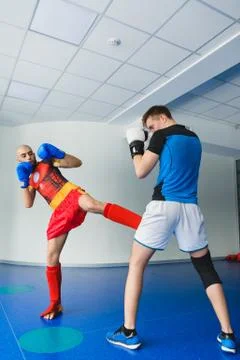 Two boxing men exercising together at the health club Stock Photos