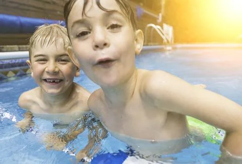 Two boy brother having fun in Pool on the summer time Stock-Fotos