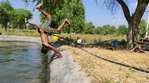 Two boy doing action jump into the pool, slow motion footage Stock Footage 134216944