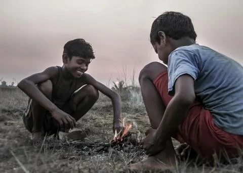 Two boy play with fire Stock Photos