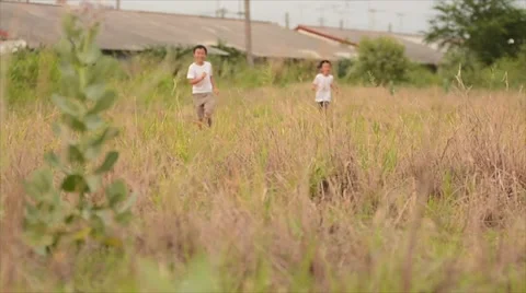 Two boy run together on the dry land Stock Footage 51802576