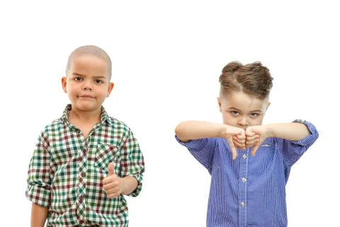 Two boy with thumbs up and thumbs down on white isolated backround Stock Photos