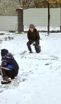 Two boys are having fun playing snowball games in the snow Stock Photos