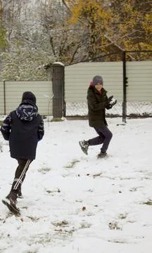 Two boys are having fun playing snowball games in the snow Stock Photos