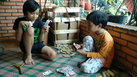 Two boys are playing cards in their house. Stock Footage 170303437