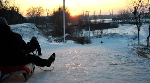 Two boys are sledding down the hill. Video stock 45987917