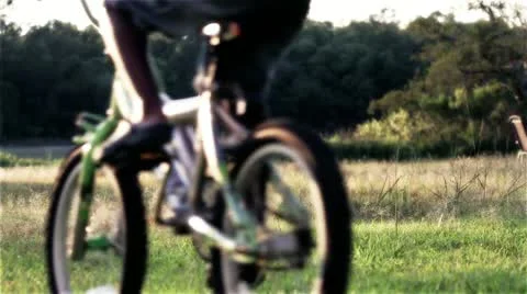 Two boys biking in summertime Stock Footage 11003354