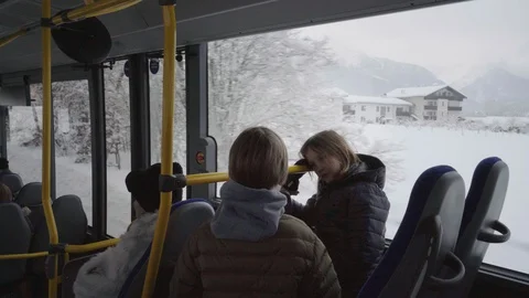 Two boys chat on a German bus while driving through winter landscape Stock Footage 120983723