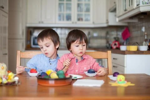 Two boys, coloring eggs for Easter Stock Photos