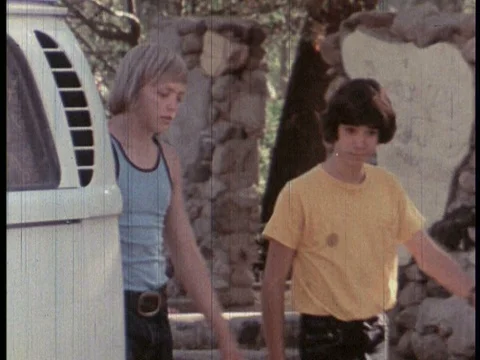 Two boys decide to take a car for a joyride in the 1970s. Stock Footage 75294272