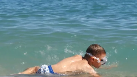 Two boys in diving mask having fun in sea waves - 4K Stock Footage 80232702