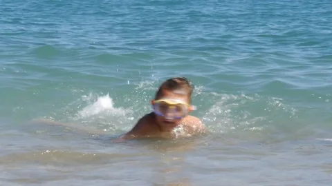 Two boys in diving mask having fun in sea waves - 4K Stock Footage 80232862