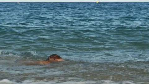 Two boys doing water gun battle in the sea Stock Footage 80231651