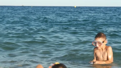 Two boys doing water gun battle in the sea Video stock 80232007