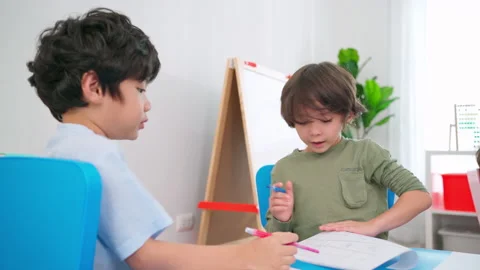 Two boys drawing together Stock Footage 188813194