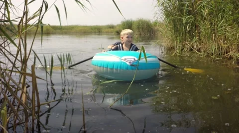 Two boys float on an inflatable boat. Video stock 66285425