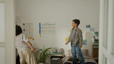Two Boys Having Fun Playing with Blue Balloon in Bedroom Stock Footage 342503173