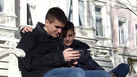 Two boys having fun on smartphone Stock Footage 49232227